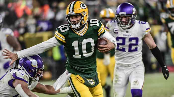 Green Bay Packers quarterback Jordan Love (10) scrambles for a first down in the fourth quarter against the Minnesota Vikings at Lambeau Field.